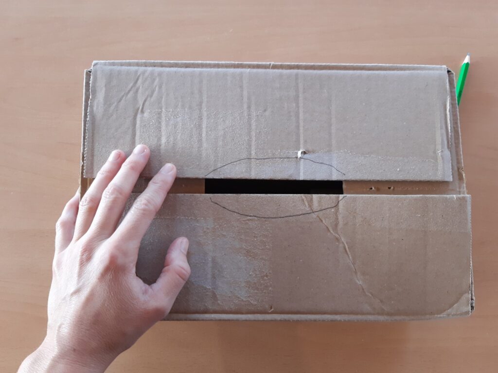 Boîte en carton fermée avec dessin pour créer une ouverture.