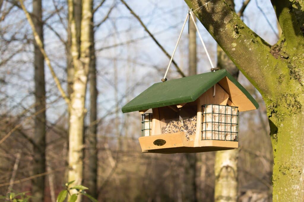 Une mangeoire en forme de maisonnette pour les oiseaux